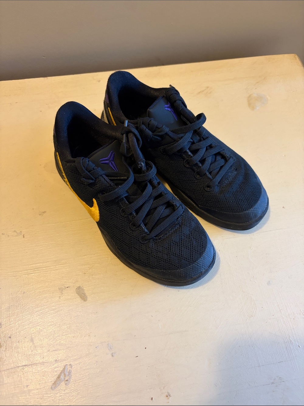 Nike Men's Black Athletic Shoes with Gold Swoosh and Purple Logo